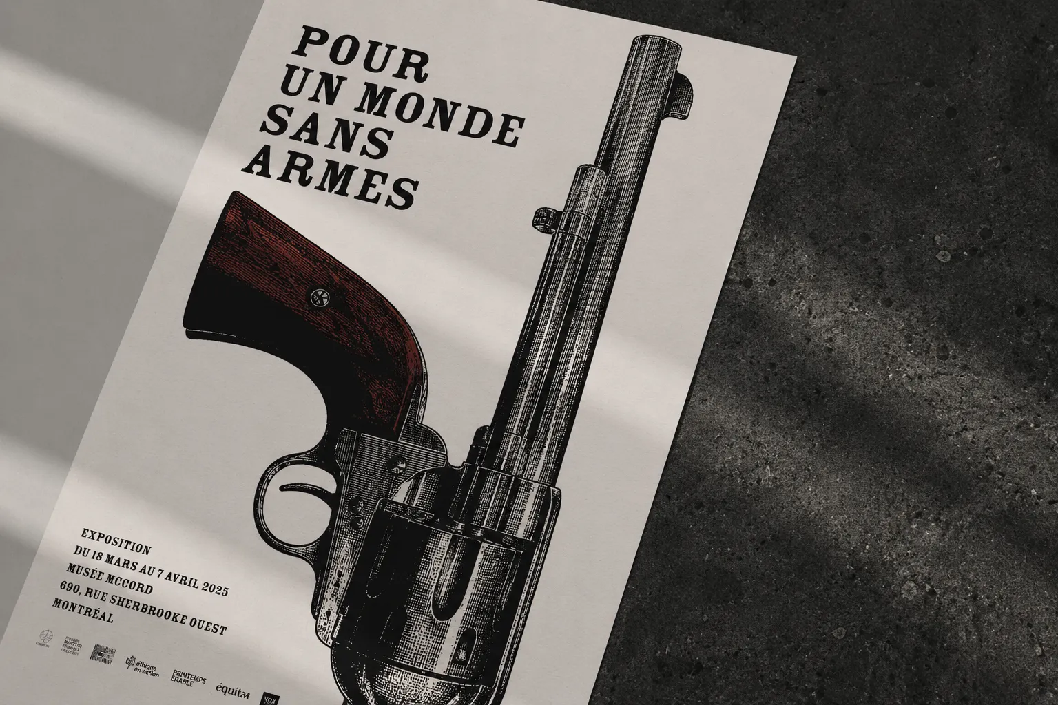 Poster with a revolver illustration and French text promoting a Montreal exhibition titled 'For a World Without Weapons.'