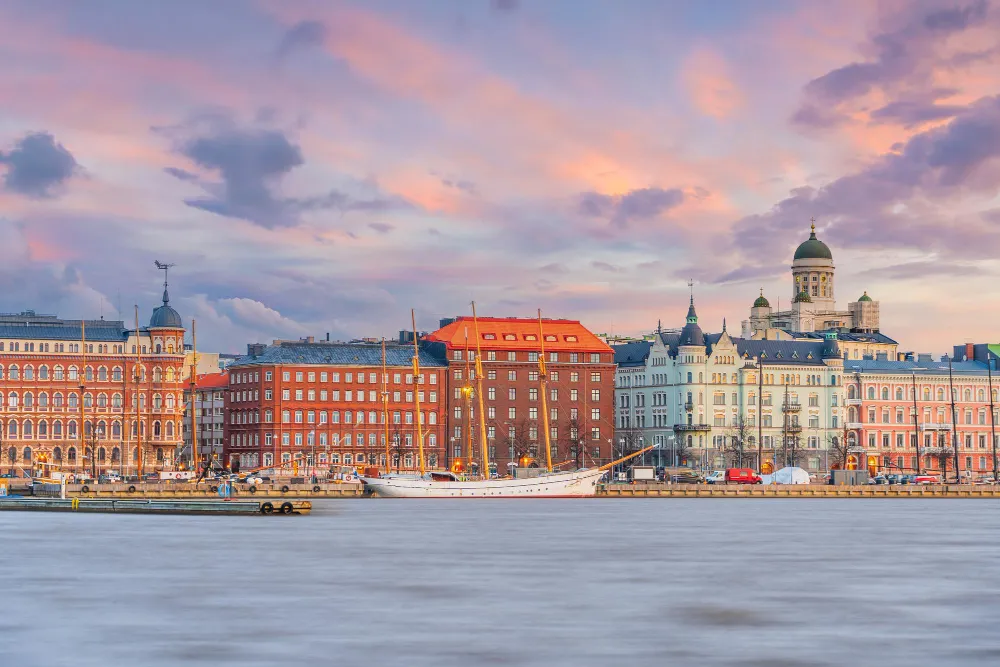 Helsinki waterfront skyline with cathedral dome at sunset
