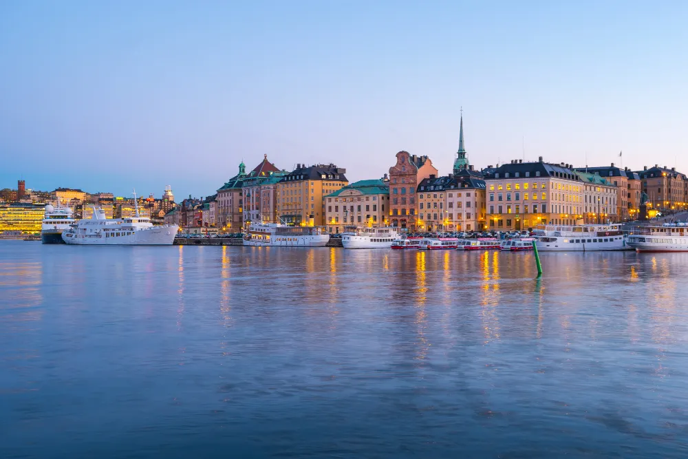 Stockholm's Gamla Stan skyline reflected in the water at dusk