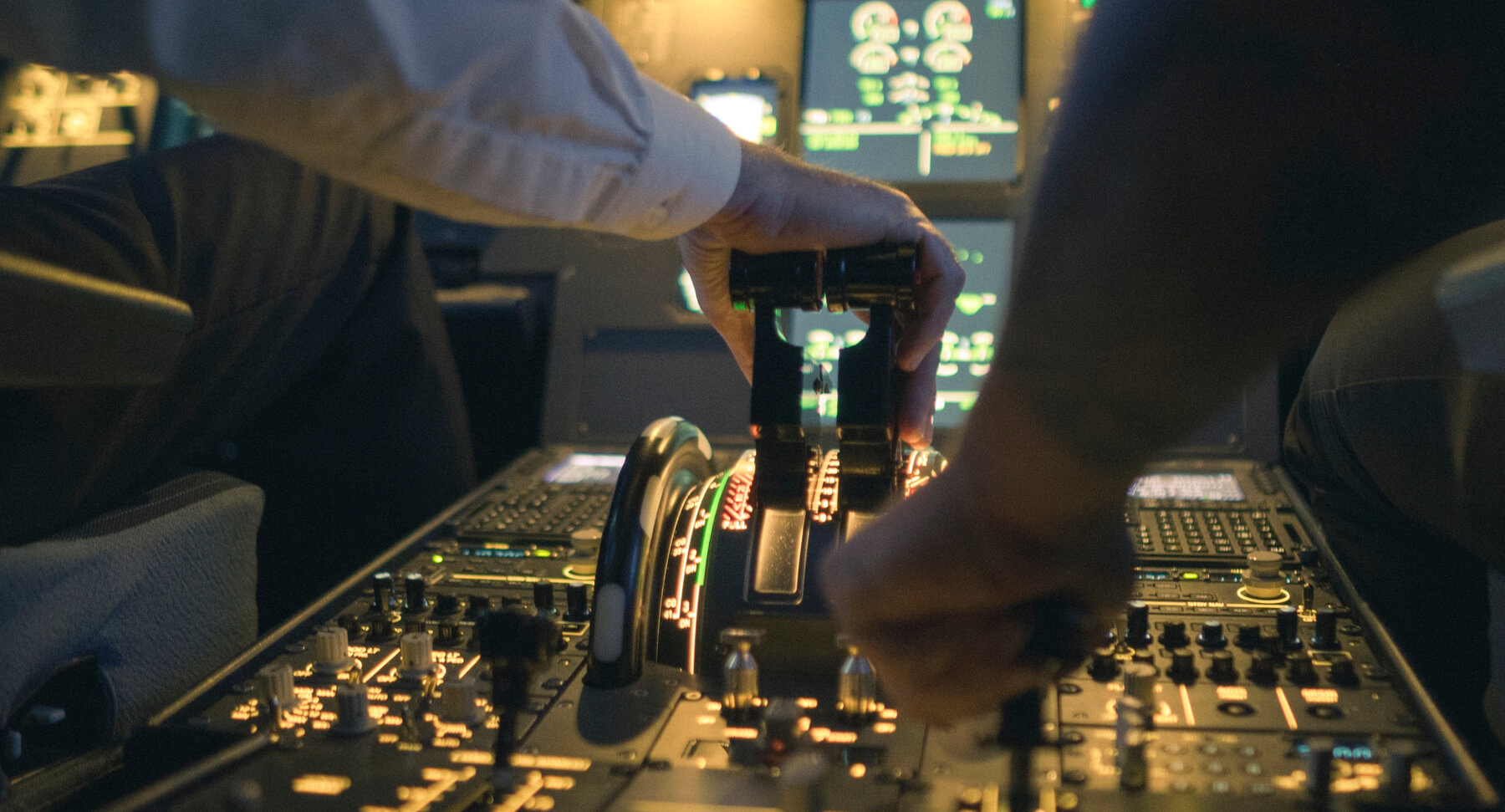 Pilot's hands on the thrust levers in an airliner simulator