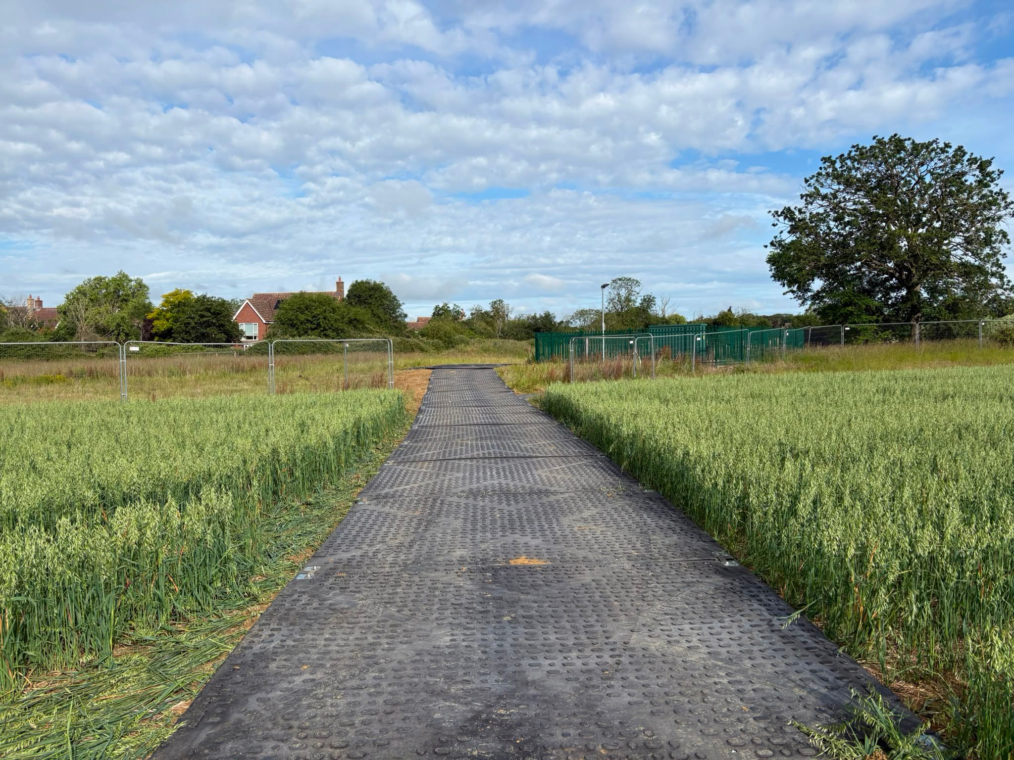 Close-up of heavy-duty ground protection mats creating a stable temporary access road for construction vehicles.