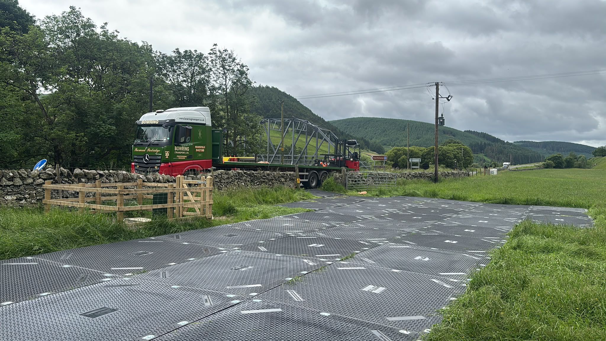 Close-up of ground protection mats being secured over sensitive terrain in Glenveg