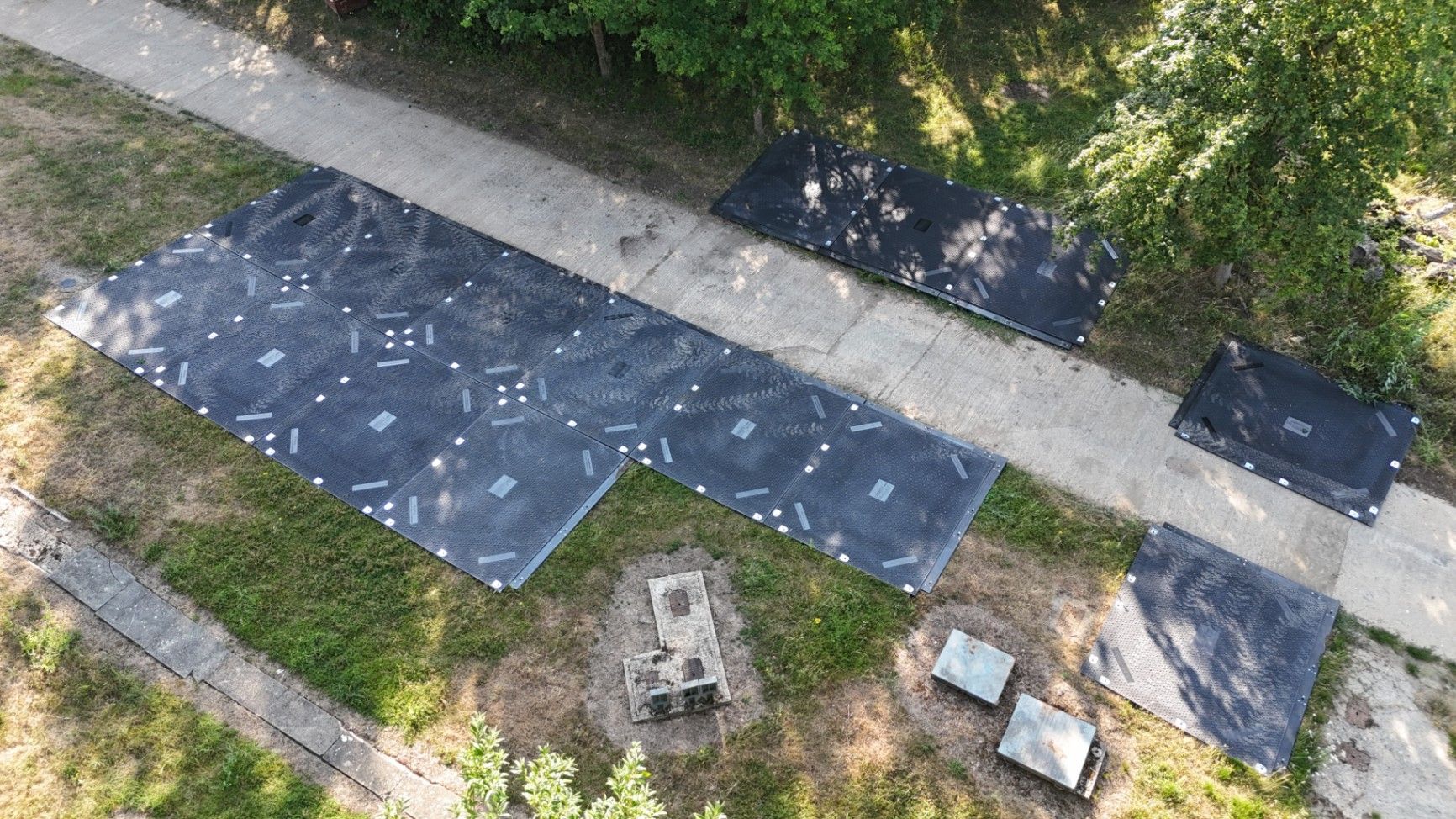 Detailed configuration of interlocking heavy-duty ground protection mats at the site