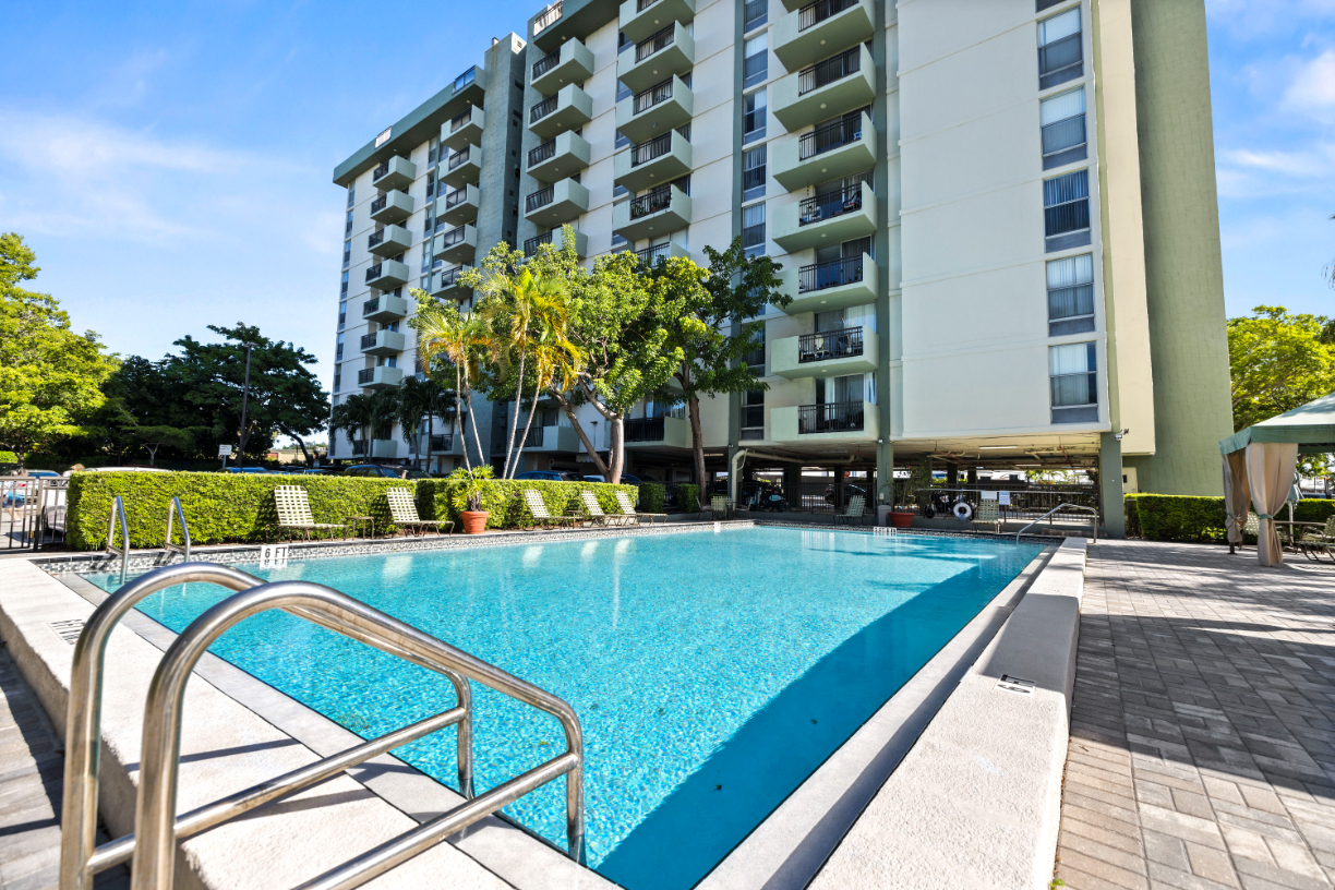 Swimming pools with lounge chairs and palm trees