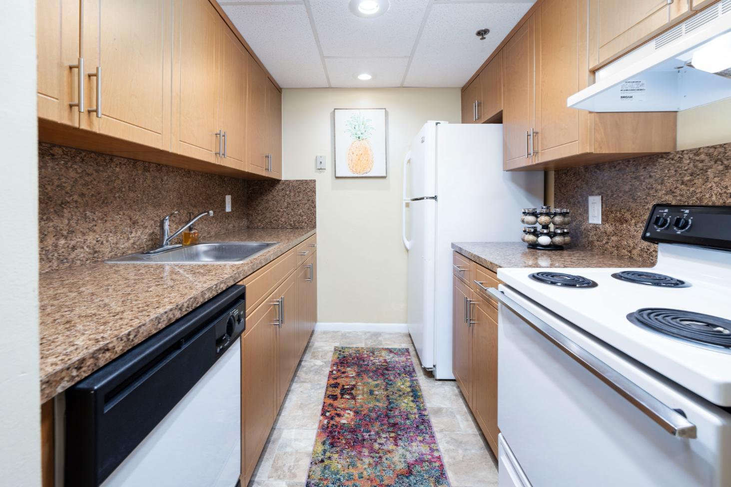 Kitchen with brown cabinets and white appliances