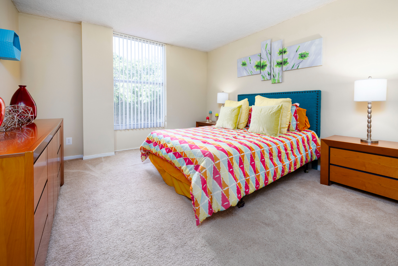 Bedroom with bed, dresser, and large window