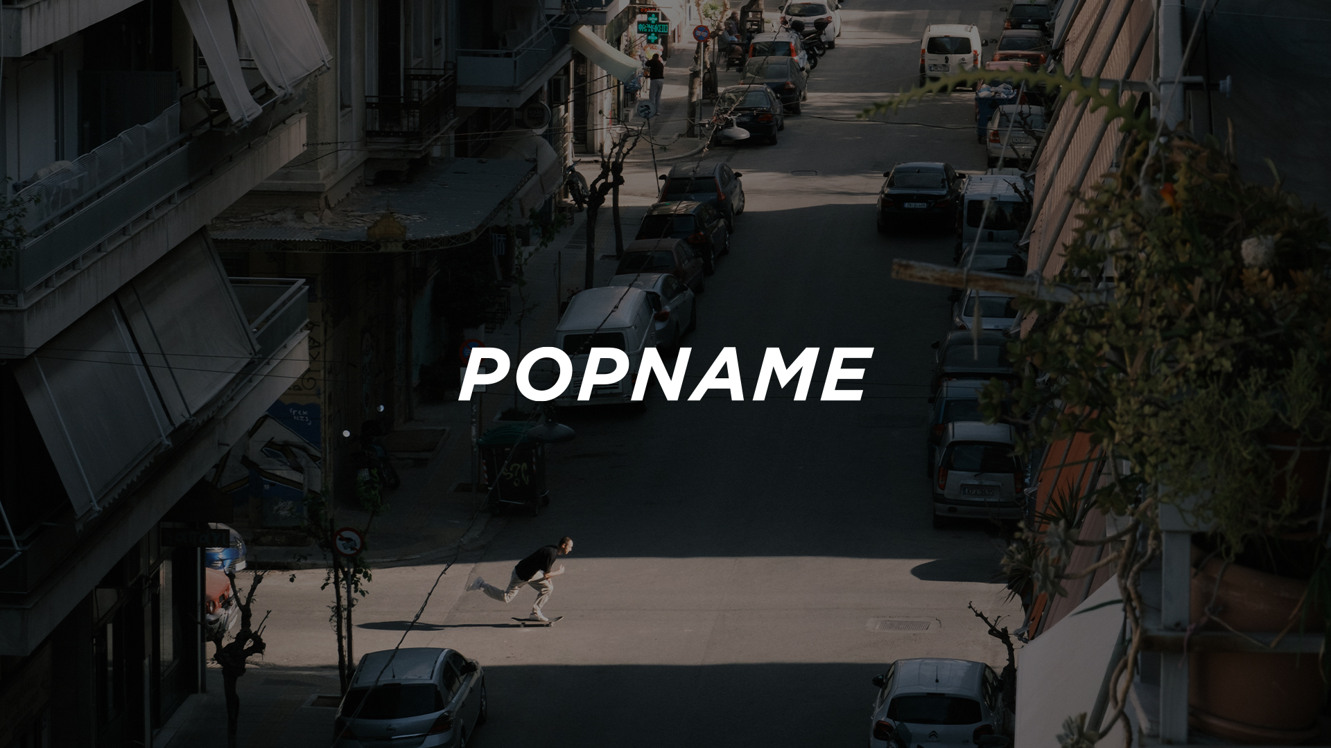 Person skateboarding across a sunlit street in a shadowed urban area with parked cars.