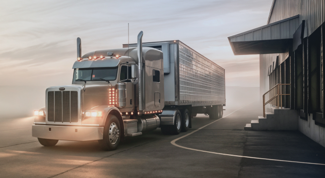 A Cargo Truck Driving At Dawn