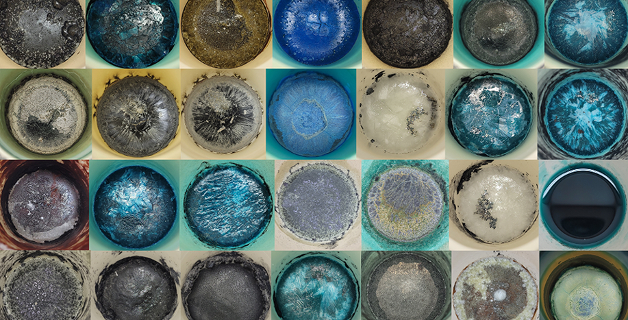 Grid of 28 circular sample containers with materials in different colors.