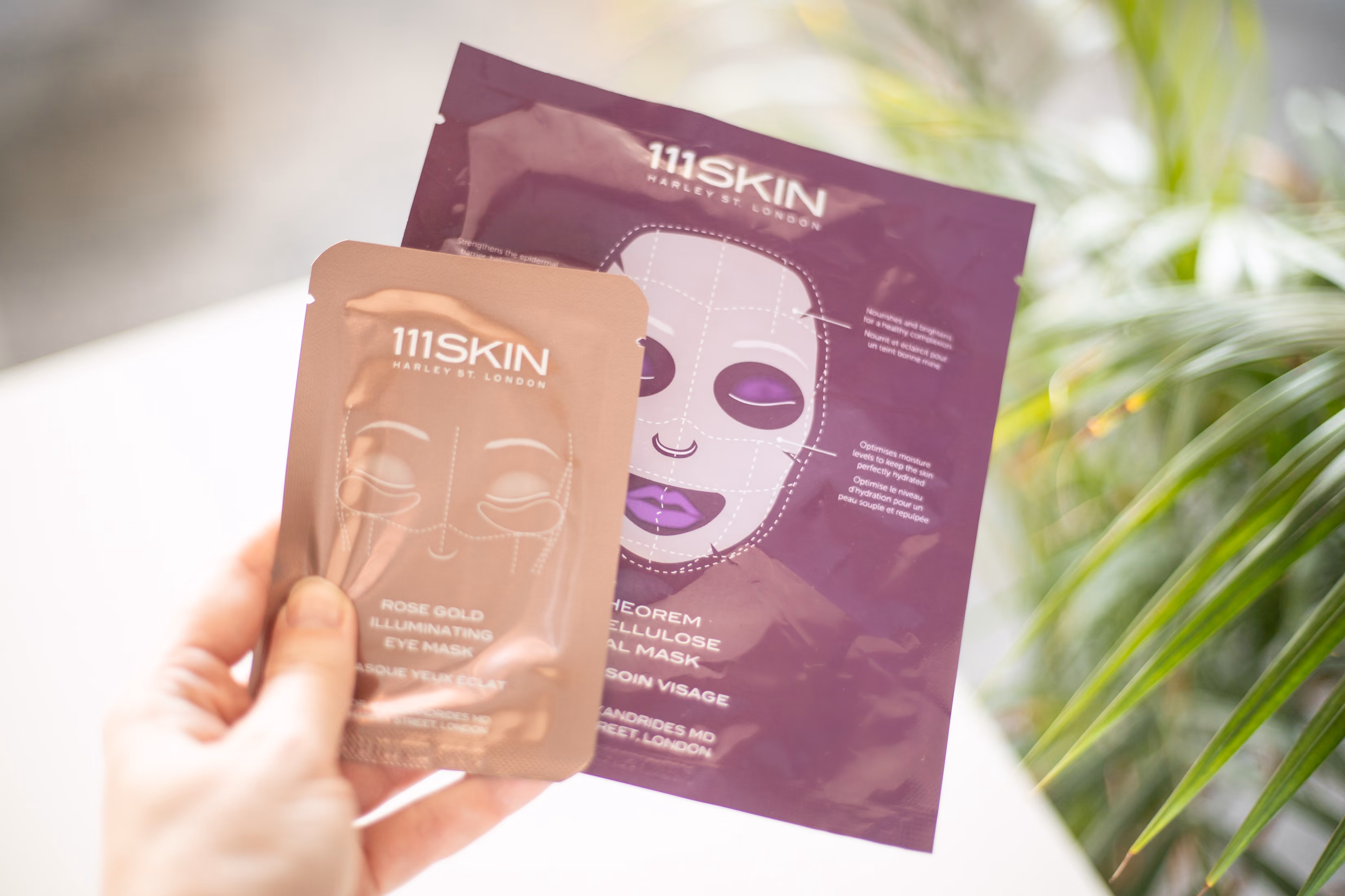 Hand holding cosmetic sheet mask products