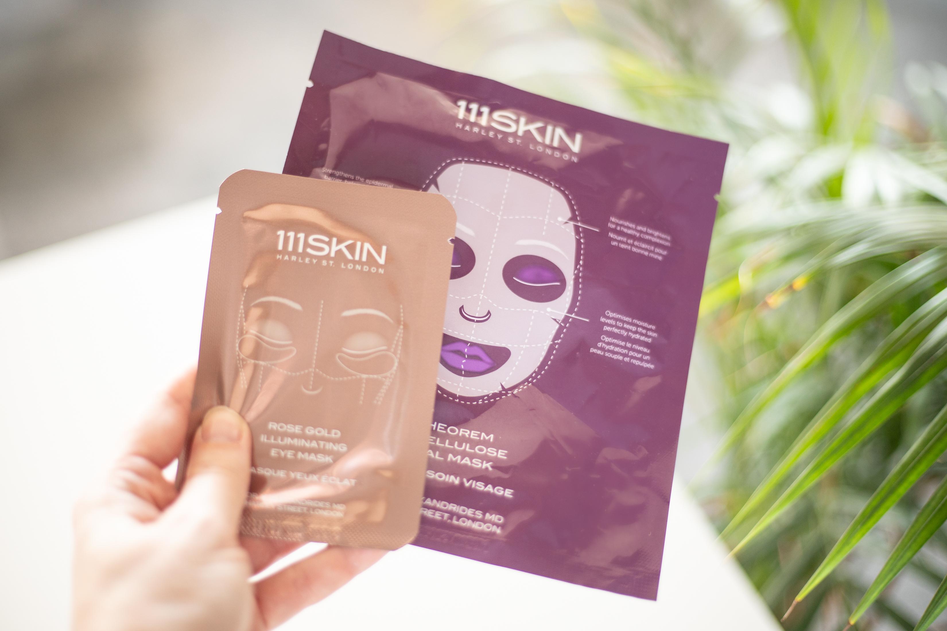 Hand holding cosmetic sheet mask products