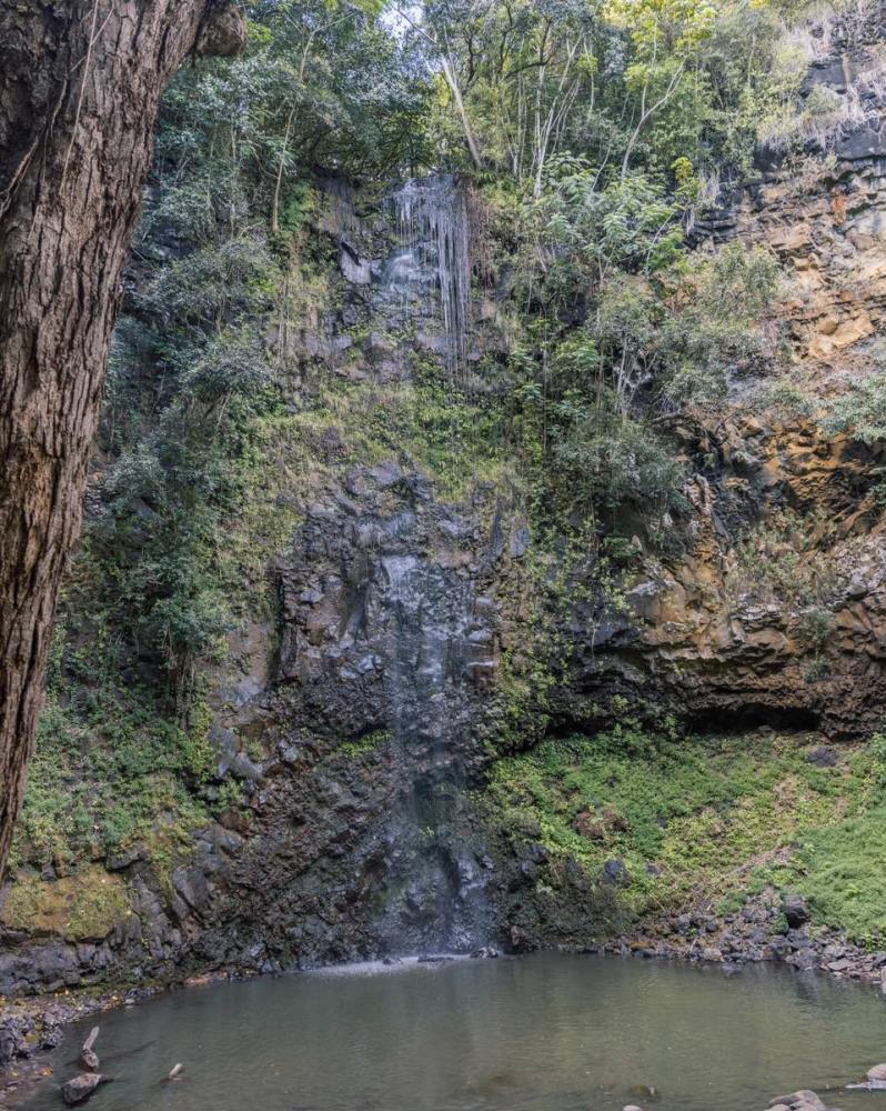 ʻUluwehi (Secret) Falls dropping into its pool on the Wailua River kayak and hike tour