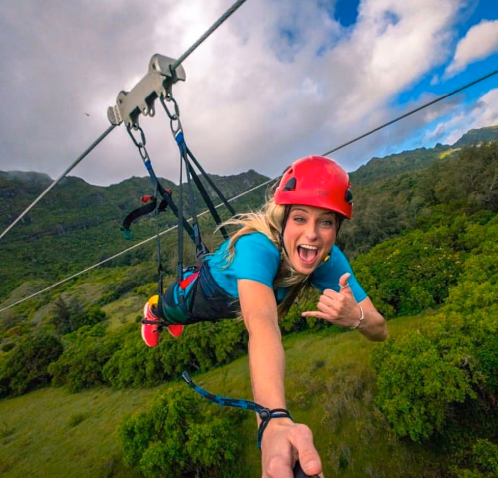 Guest flying Superman-style on the FlyLine, Hawaiʻi’s longest zipline, during the Nui Kauai Zipline tour at Kipu Ranch.