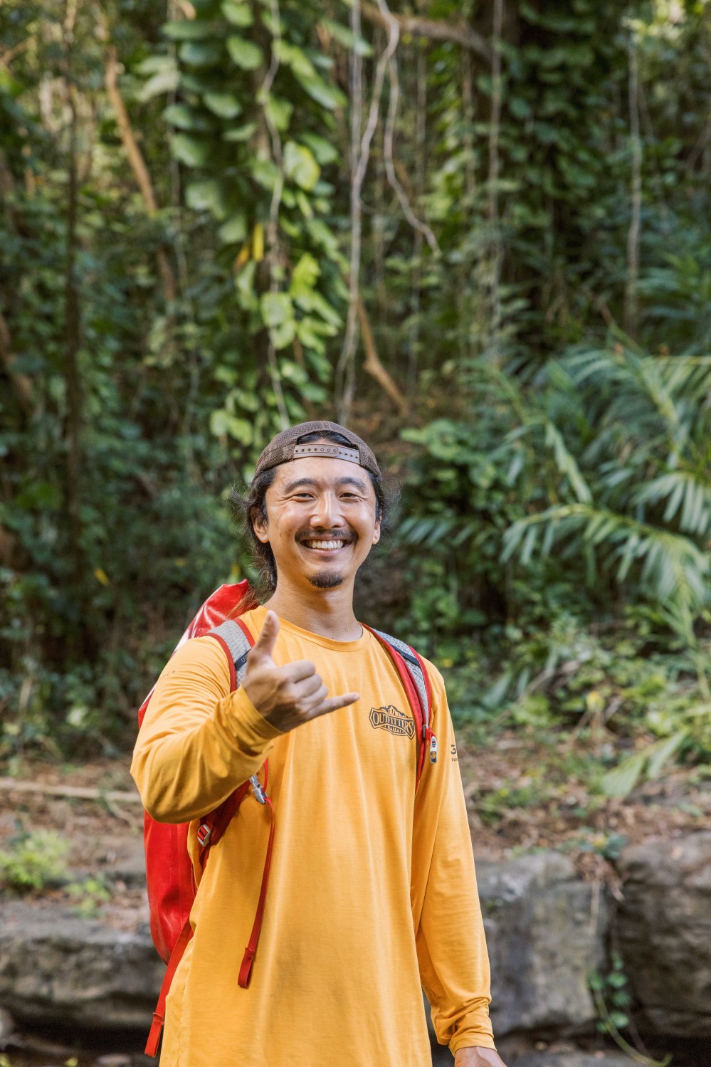 Outfitters Kauai guide giving a shaka in the jungle on the Hidden Valley Falls hike