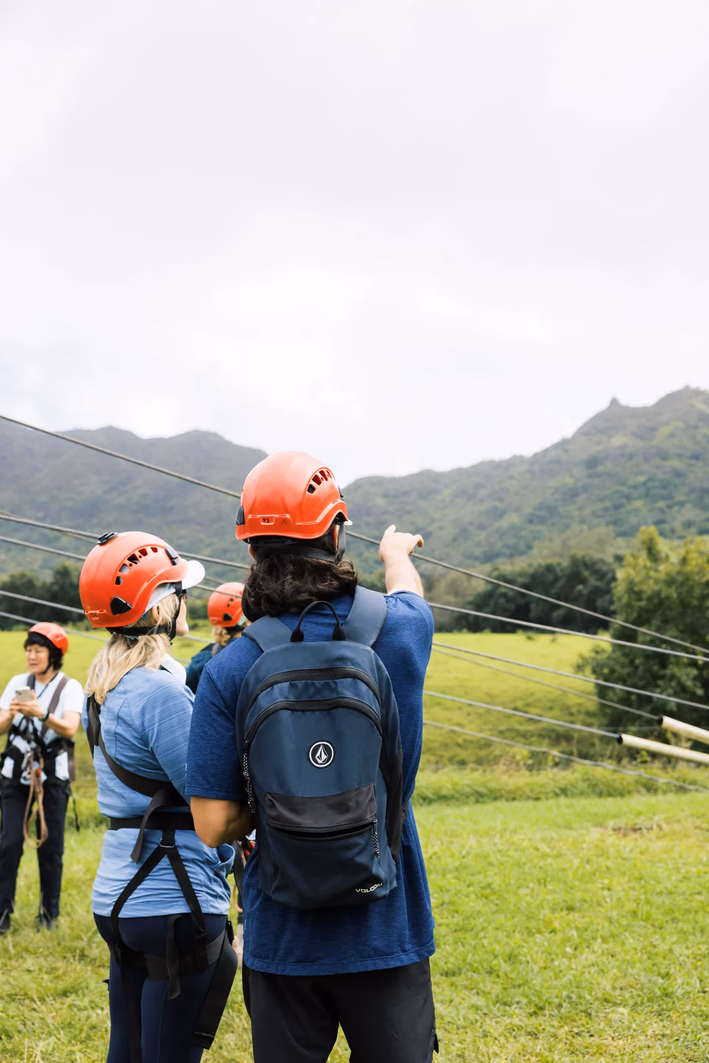 Zipline tour participants receiving safety instructions with Kauai valley views behind them