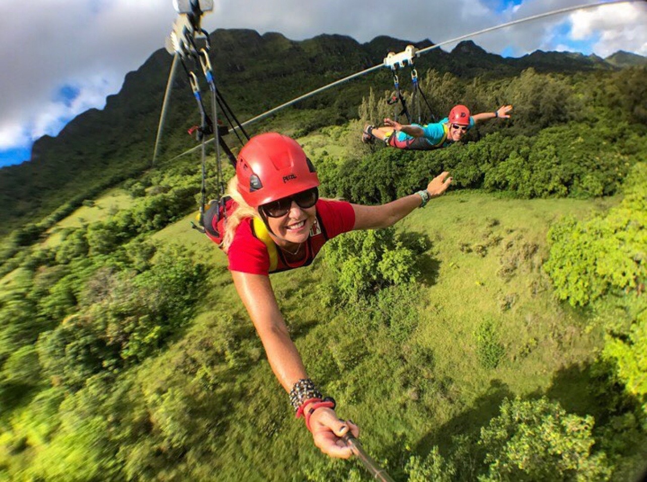Guest ziplining on Hawaii's longest zipline the FlyLine with Outfitters Kauai