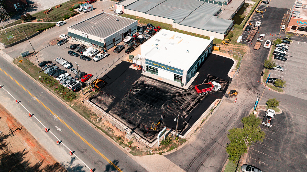 Aerial view of dump truck delivering asphalt during new parking lot paving at Mavis Tire & Brakes, Greensboro NC