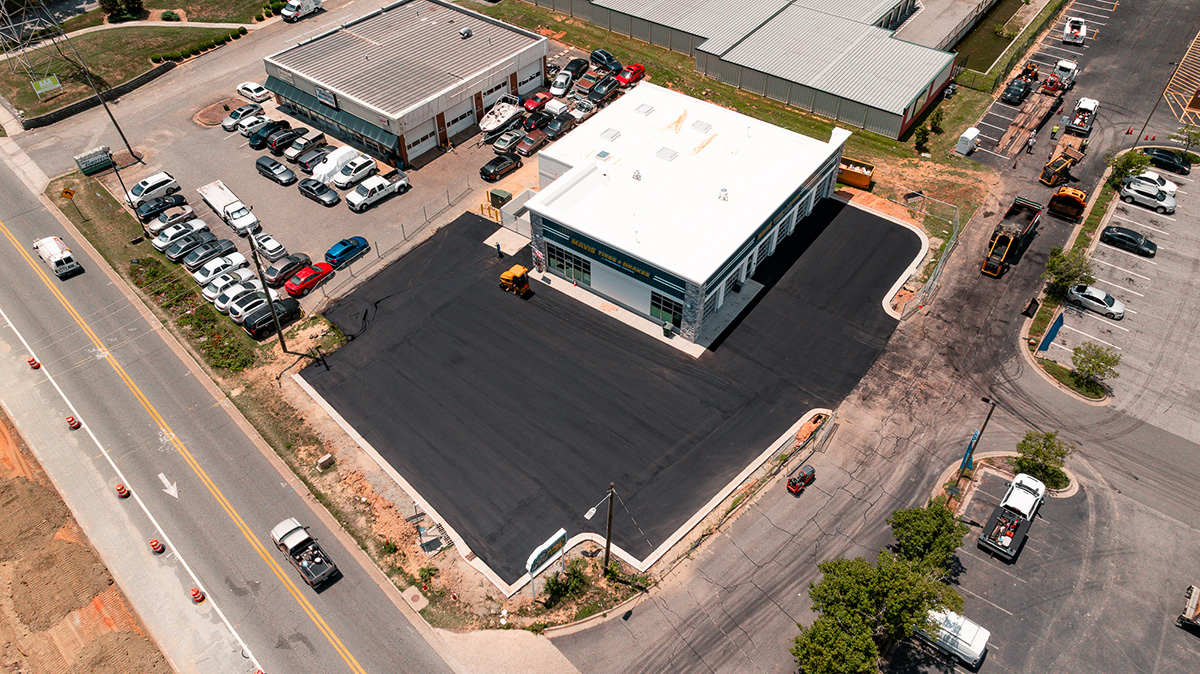 Aerial view of freshly paved parking lot at newly constructed Mavis Tire & Brakes location, Greensboro NC