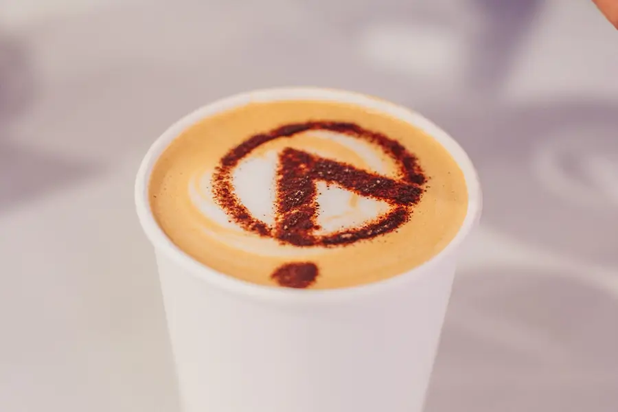Branded Anaqua coffee bar providing an informal meeting area on the exhibition stand