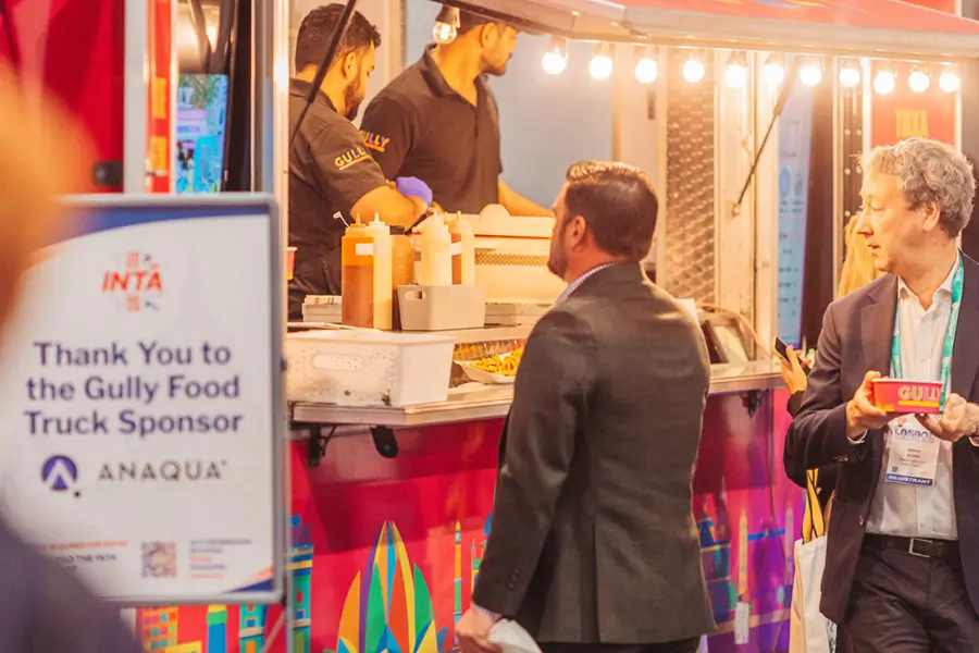 Anaqua branded food truck serving delegates inside the exhibition hall