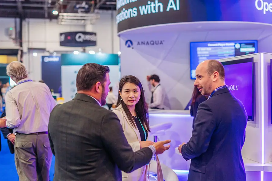 Anaqua team speaking with visitors beside the stand’s demonstration areas