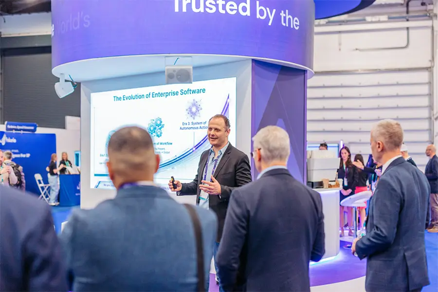 Visitors gathering around the Anaqua exhibition stand during the conference