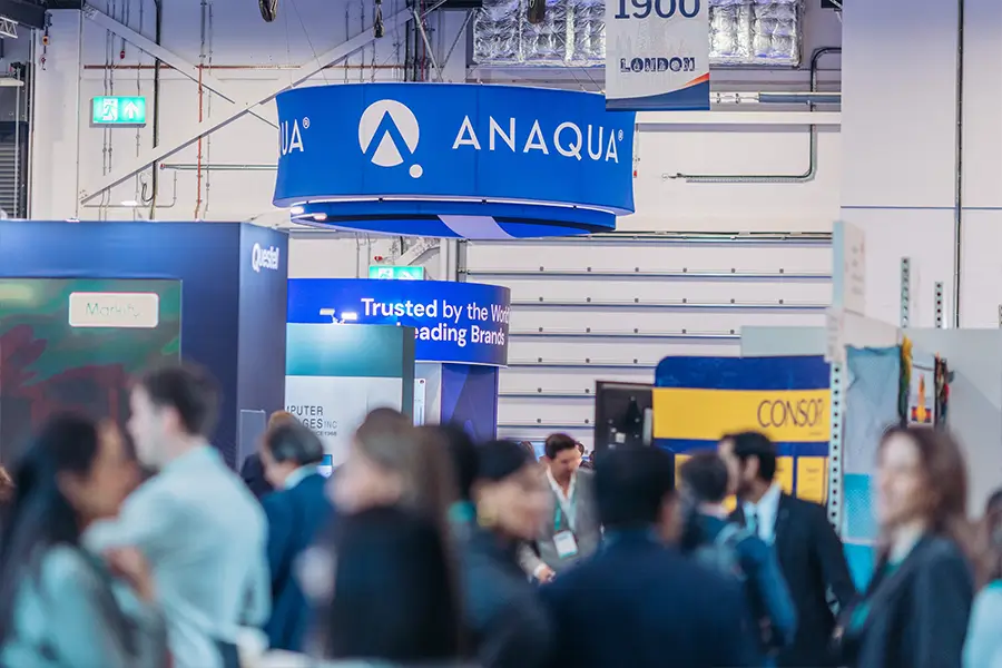 Illuminated Anaqua hanging sign positioned above the exhibition stand