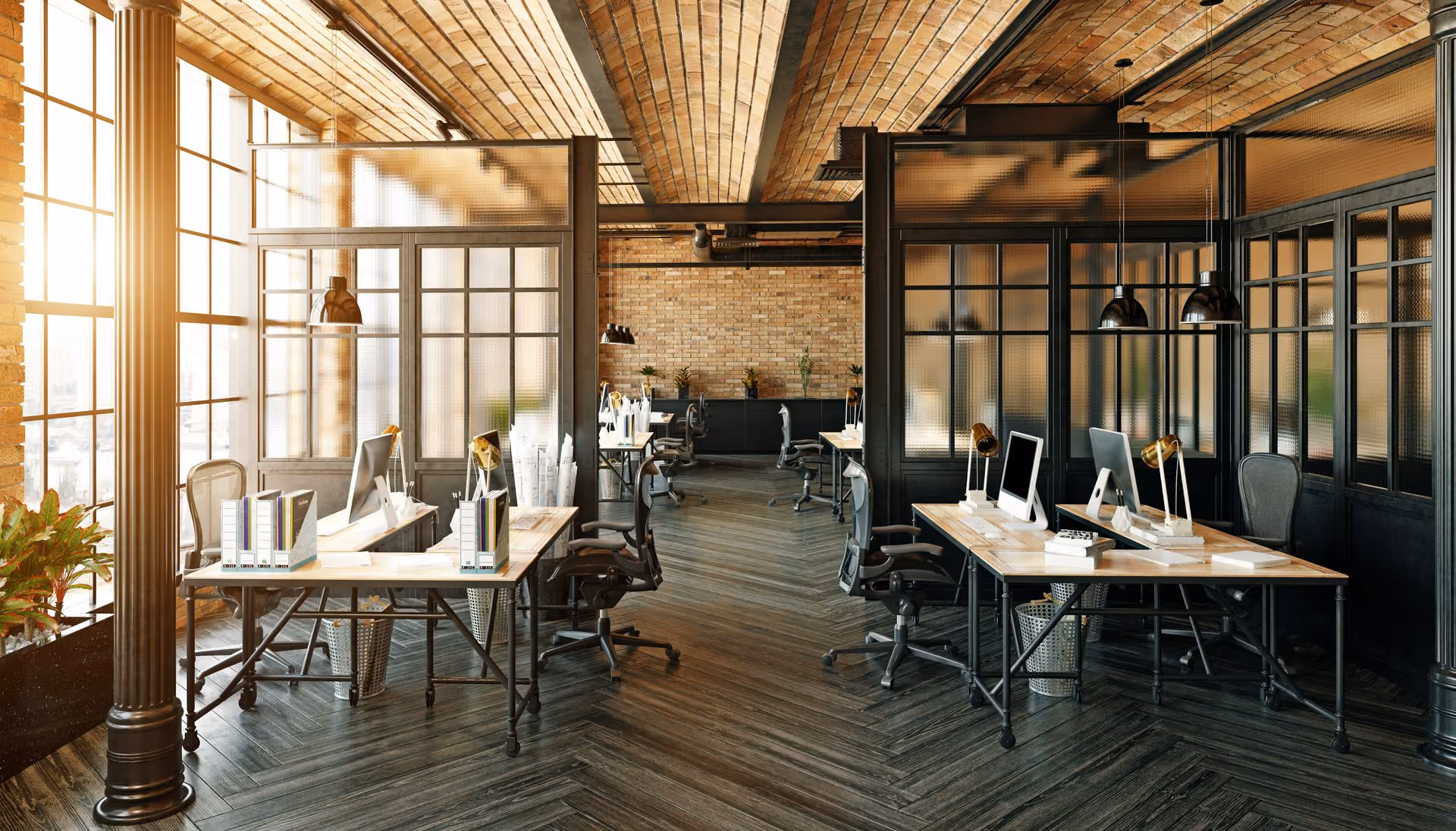 Modern office interior with wooden ceiling, black-framed glass partitions, desks, chairs, and computer monitors.