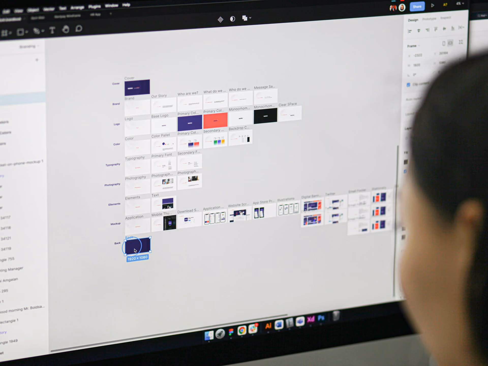 Person looking at a computer screen displaying a design project with labeled sections and thumbnails.