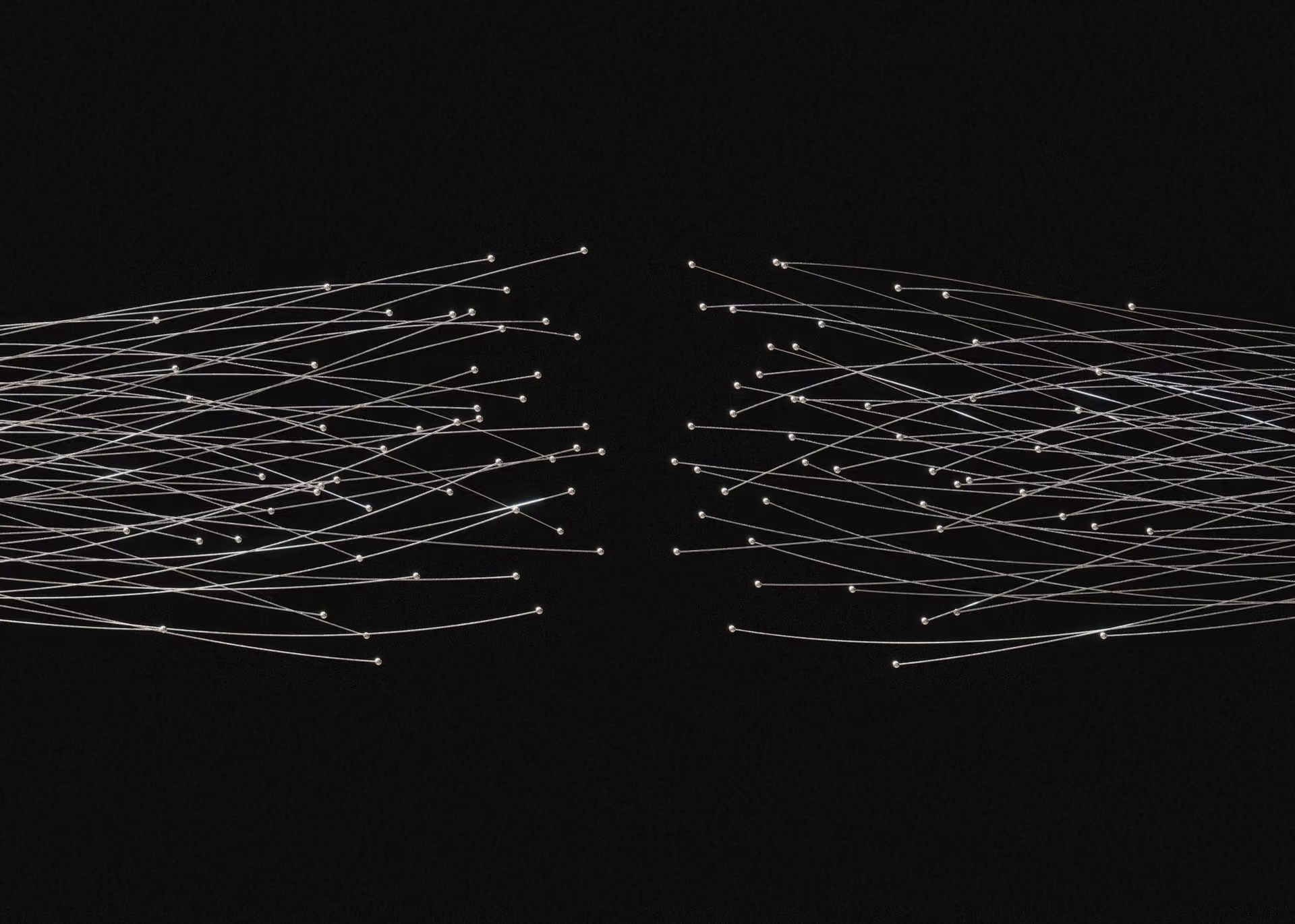 Thin white wires with small glowing tips spread symmetrically on both sides over black background.