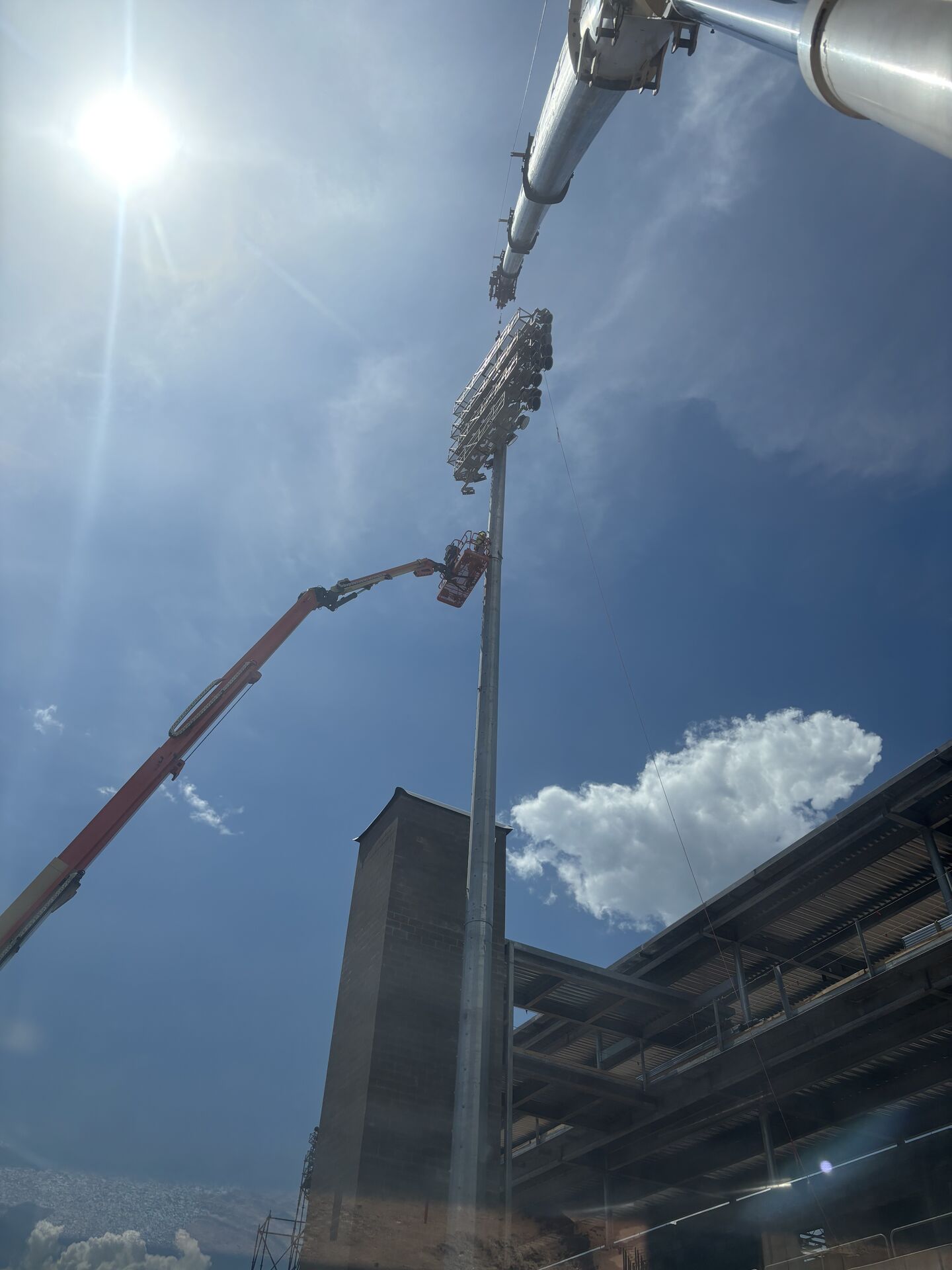 Crane boom extended against the sky