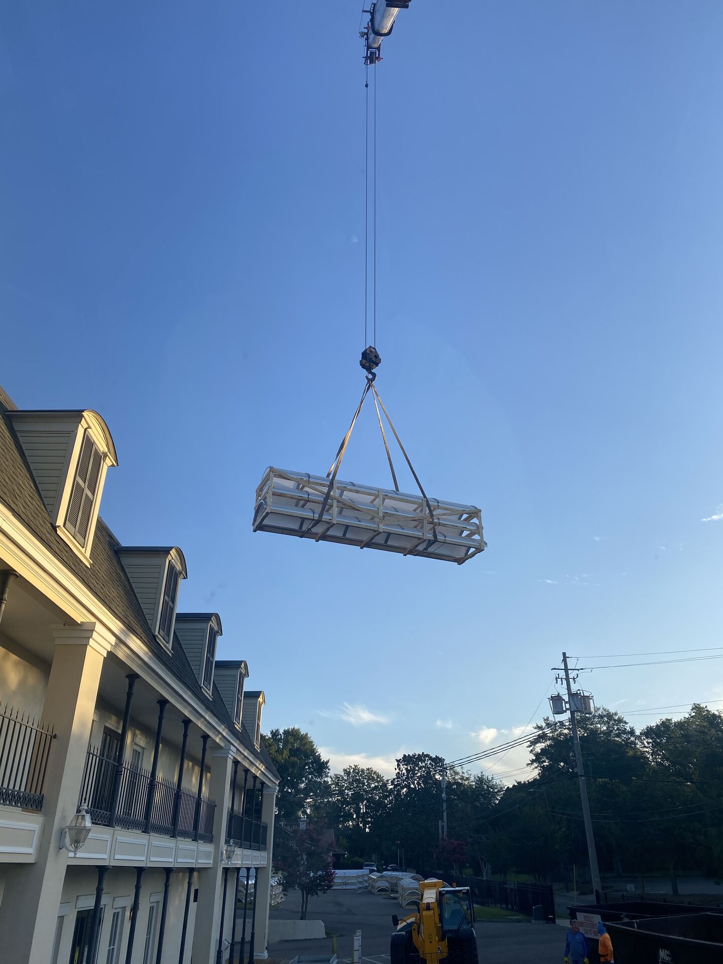 Crane lift against a bright blue sky