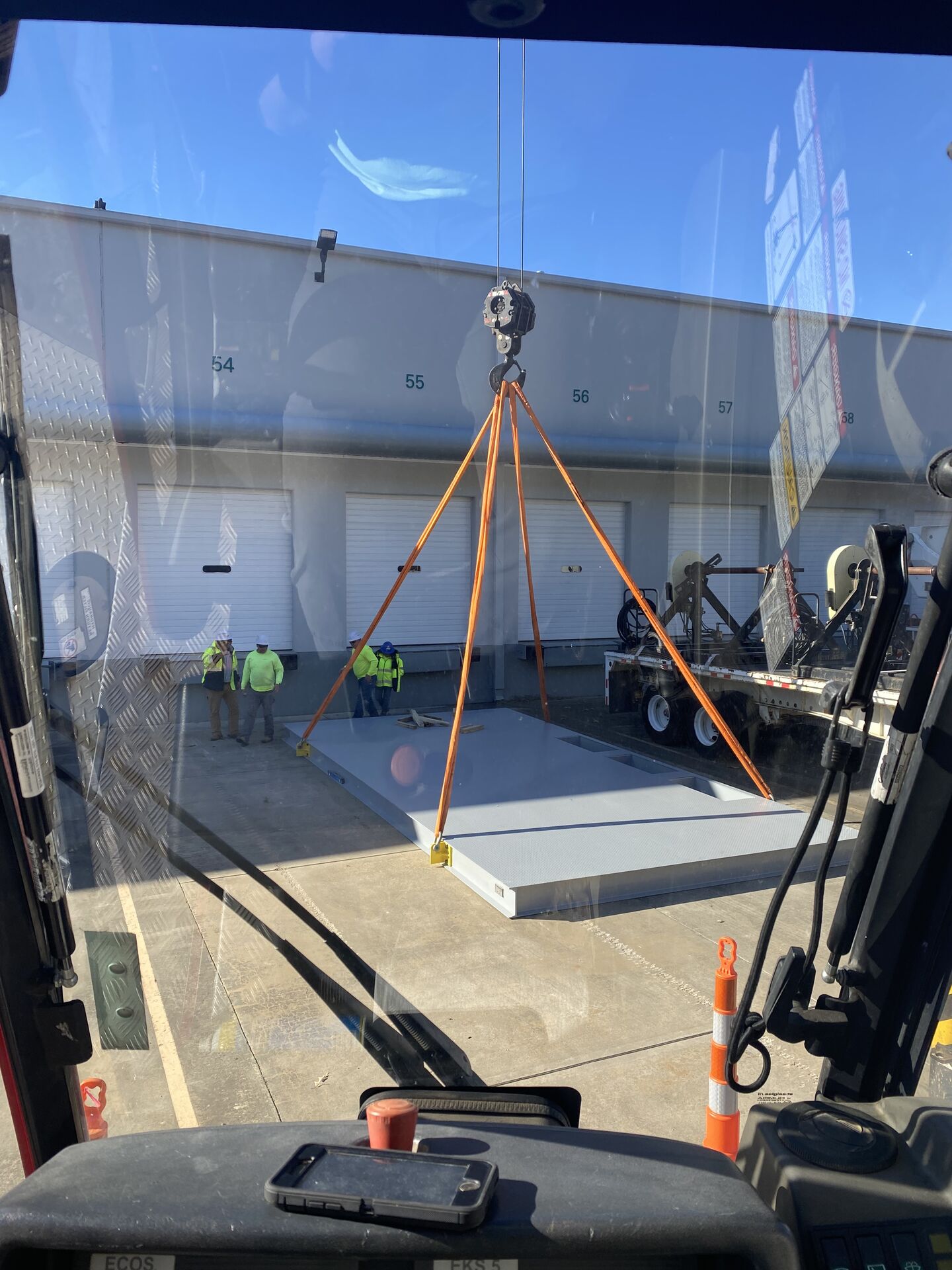 Crane setting materials at a foundation construction site
