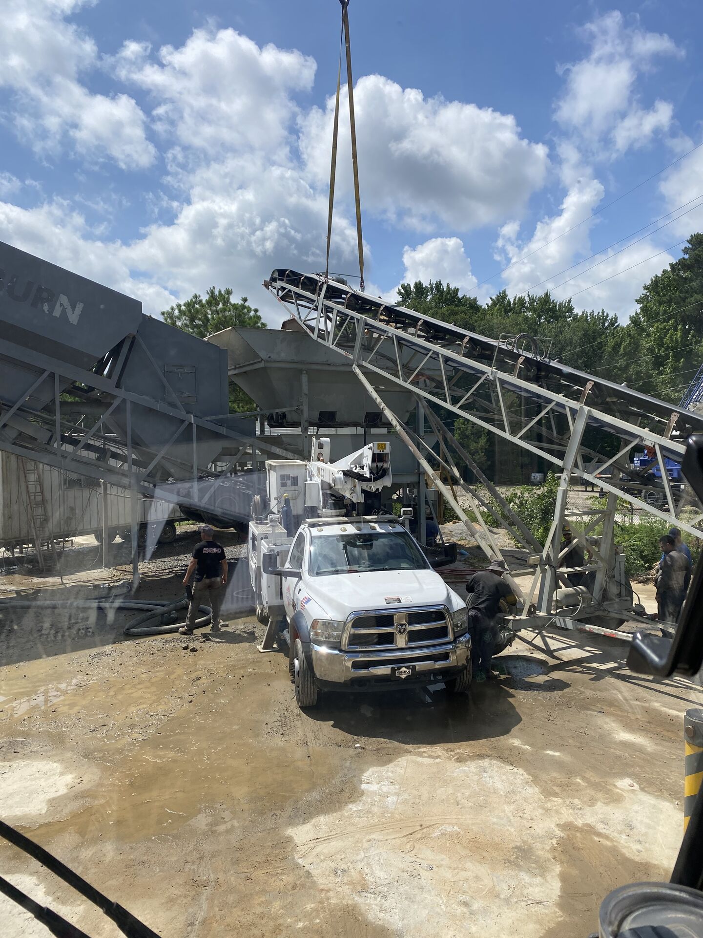 Crane handling heavy equipment at a jobsite