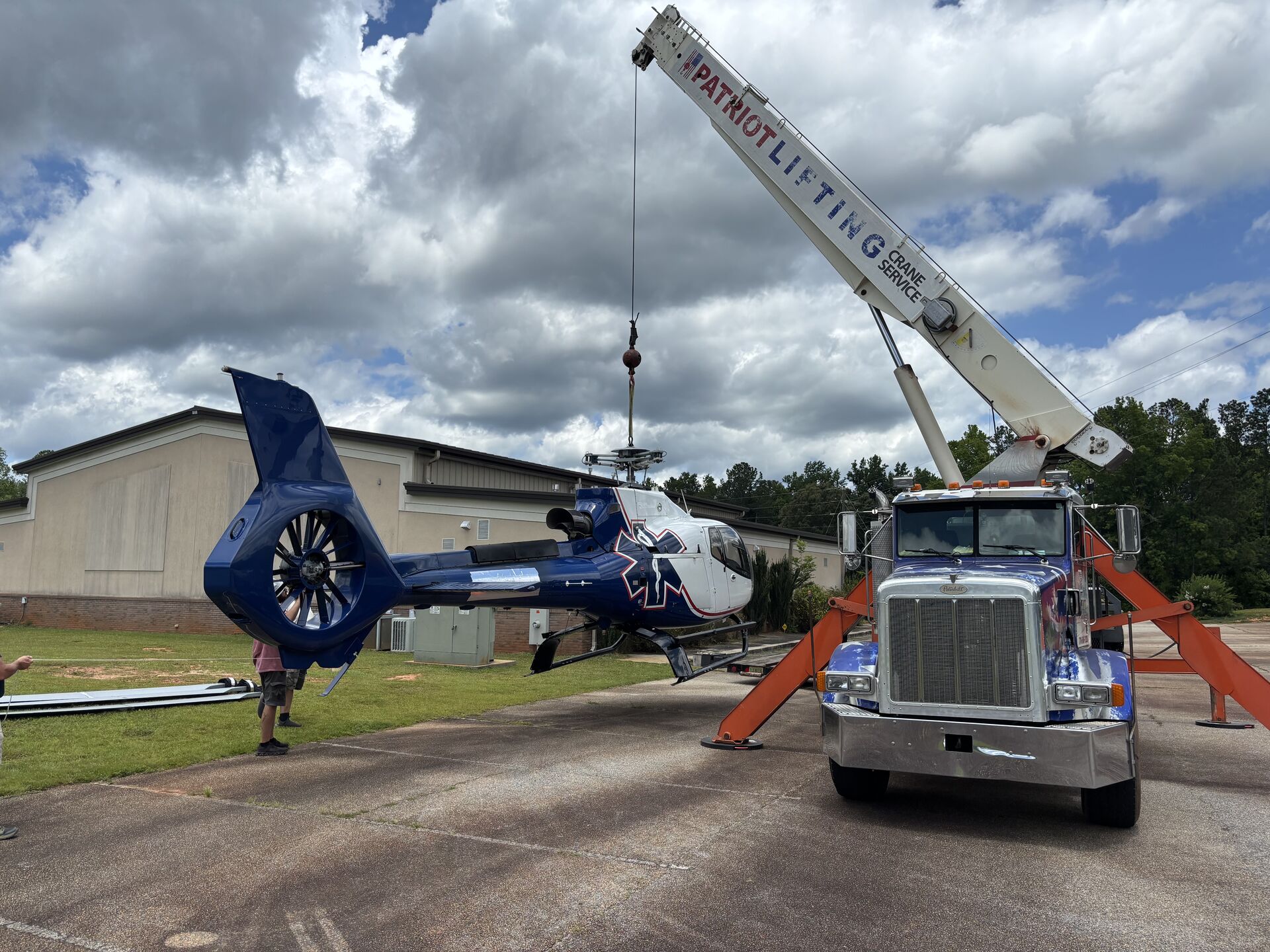 Crane working with heavy machinery at a jobsite