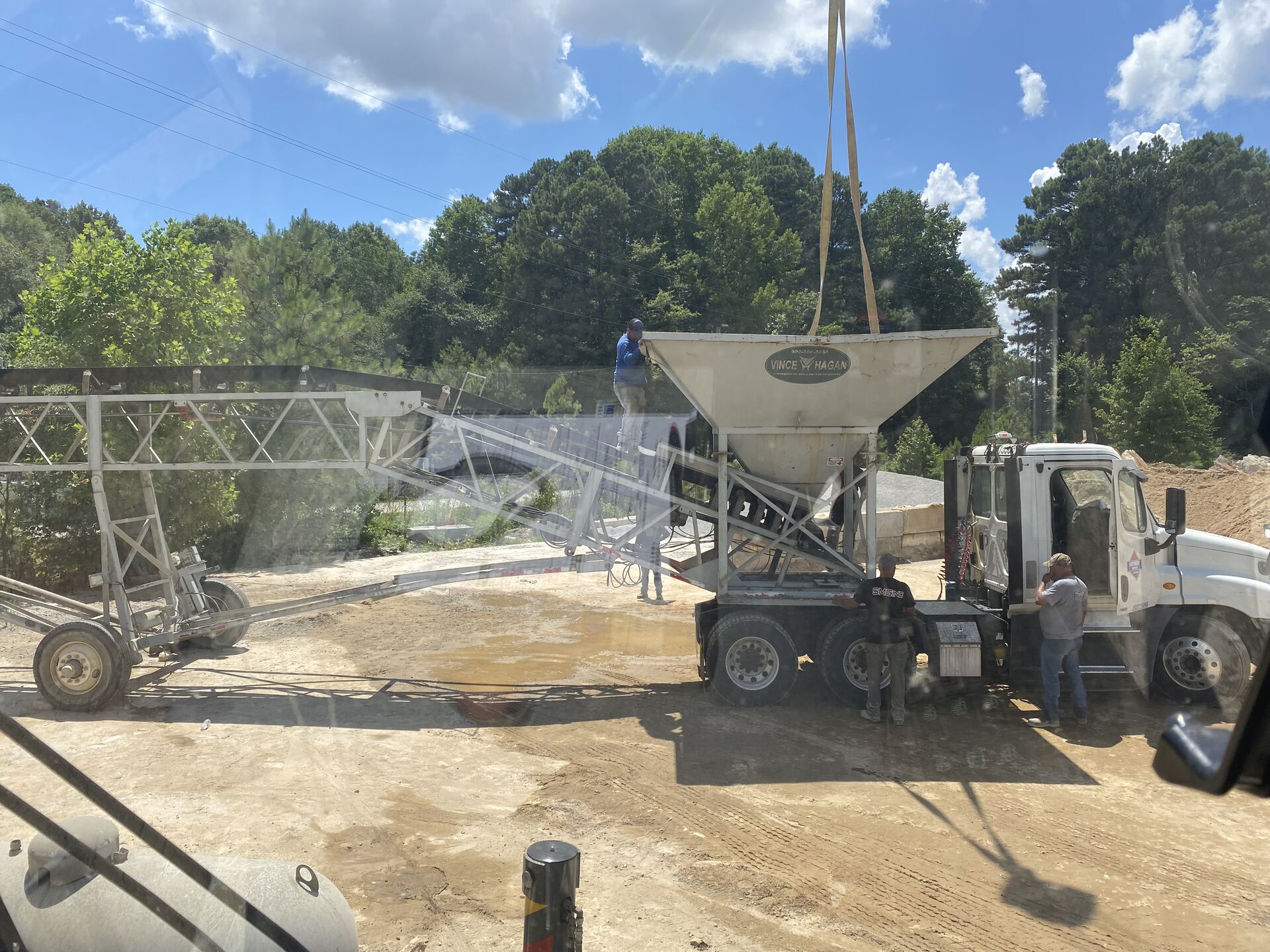Crane lifting heavy machinery at a job