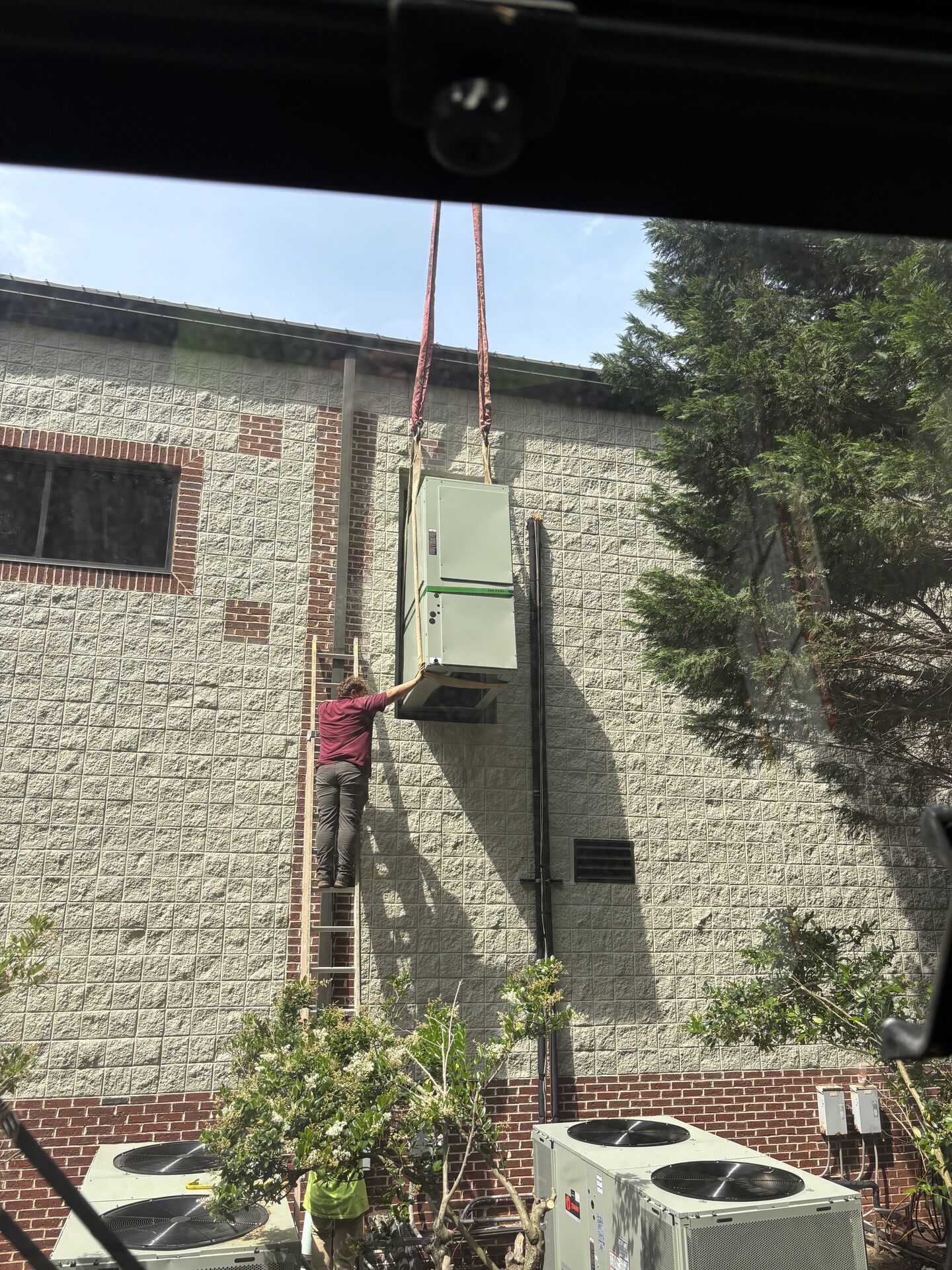 Crane working at a brick wall construction project