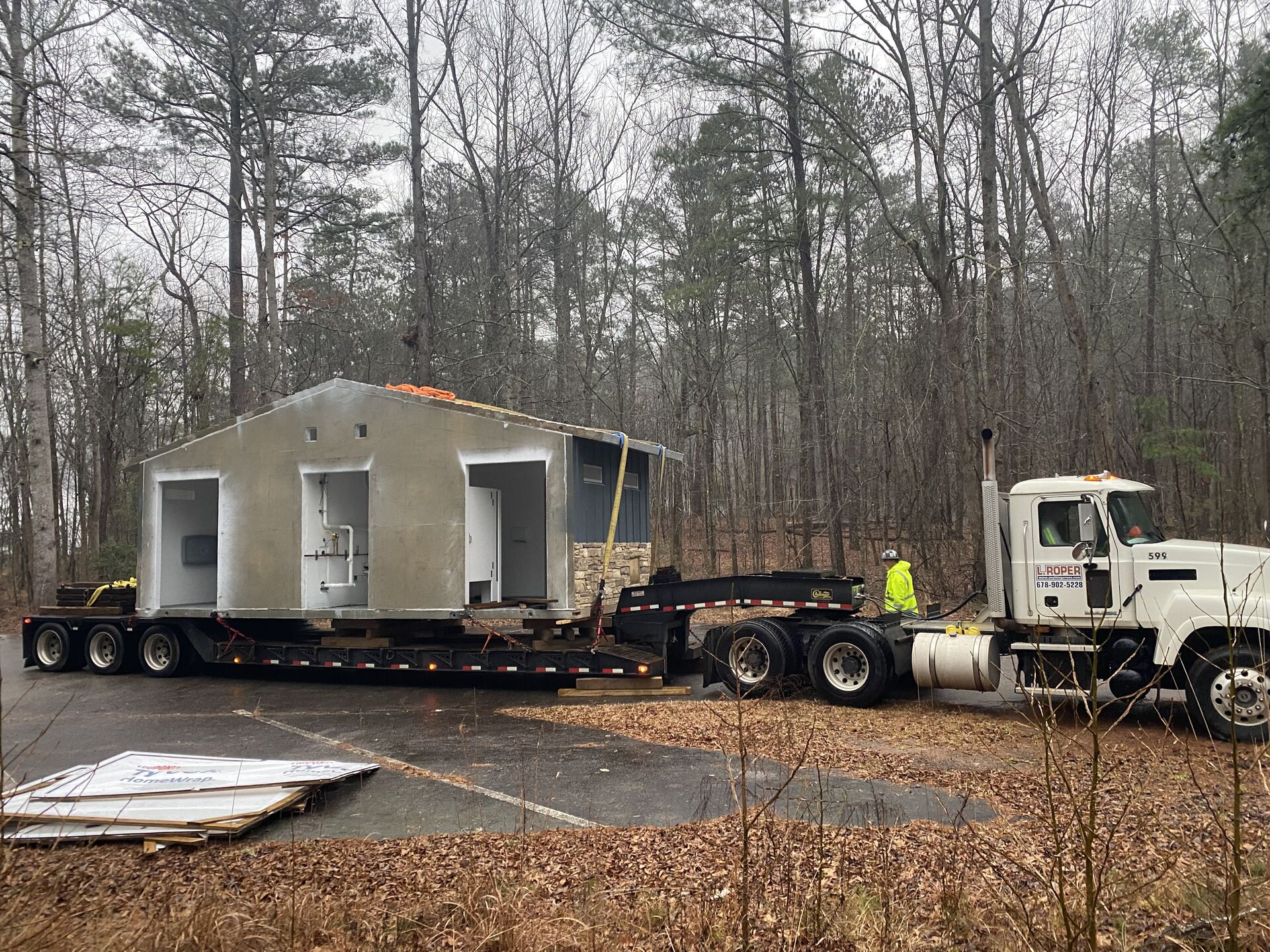 Crane lifting a mobile home into position