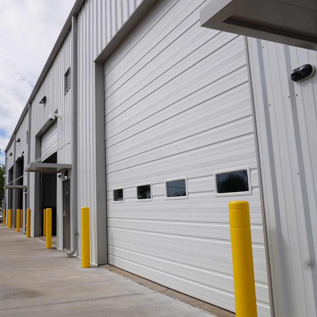 Patriot Lifting Jenkinsburg headquarters exterior with bay doors and yellow bollards