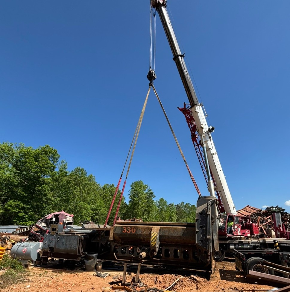 White Grove TMS9000E truck crane lifting wreckage at an automotive scrap yard