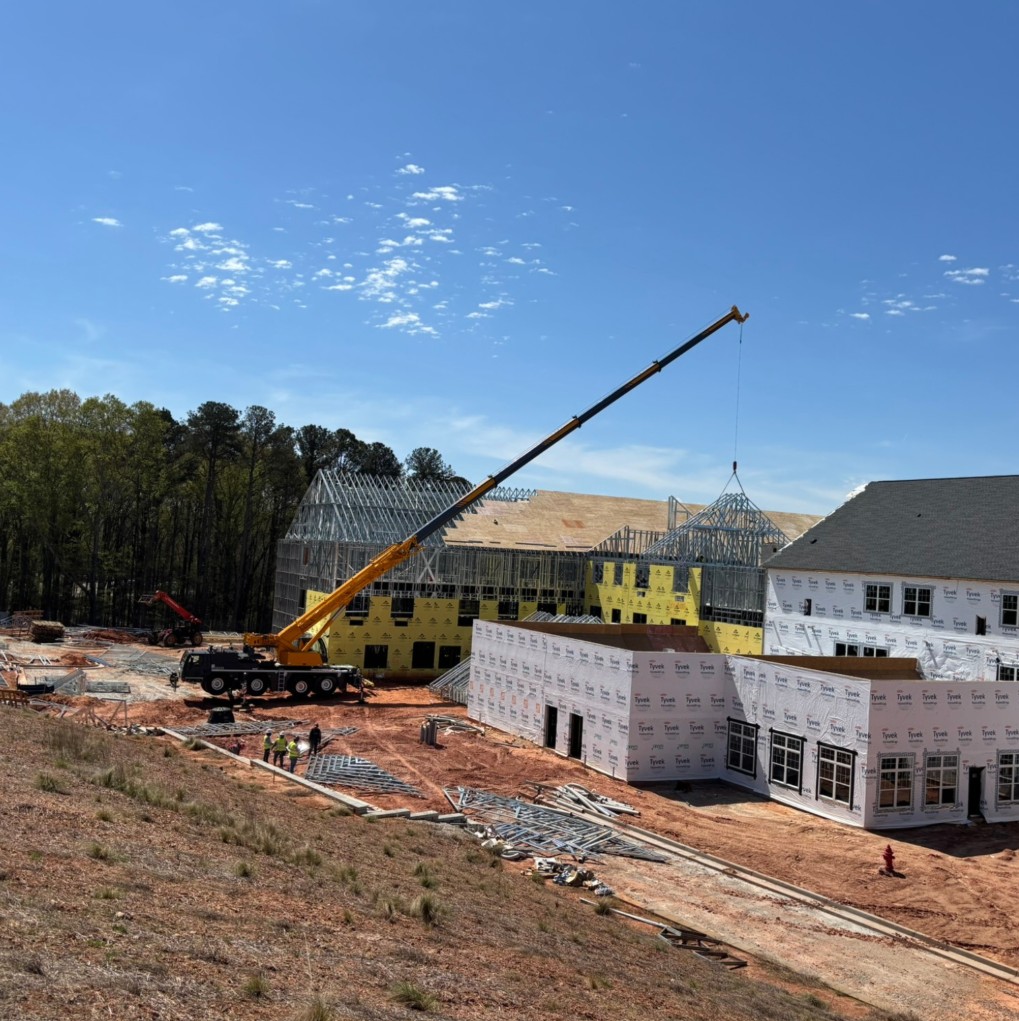 Yellow Grove crane working at a multi-family residential construction site