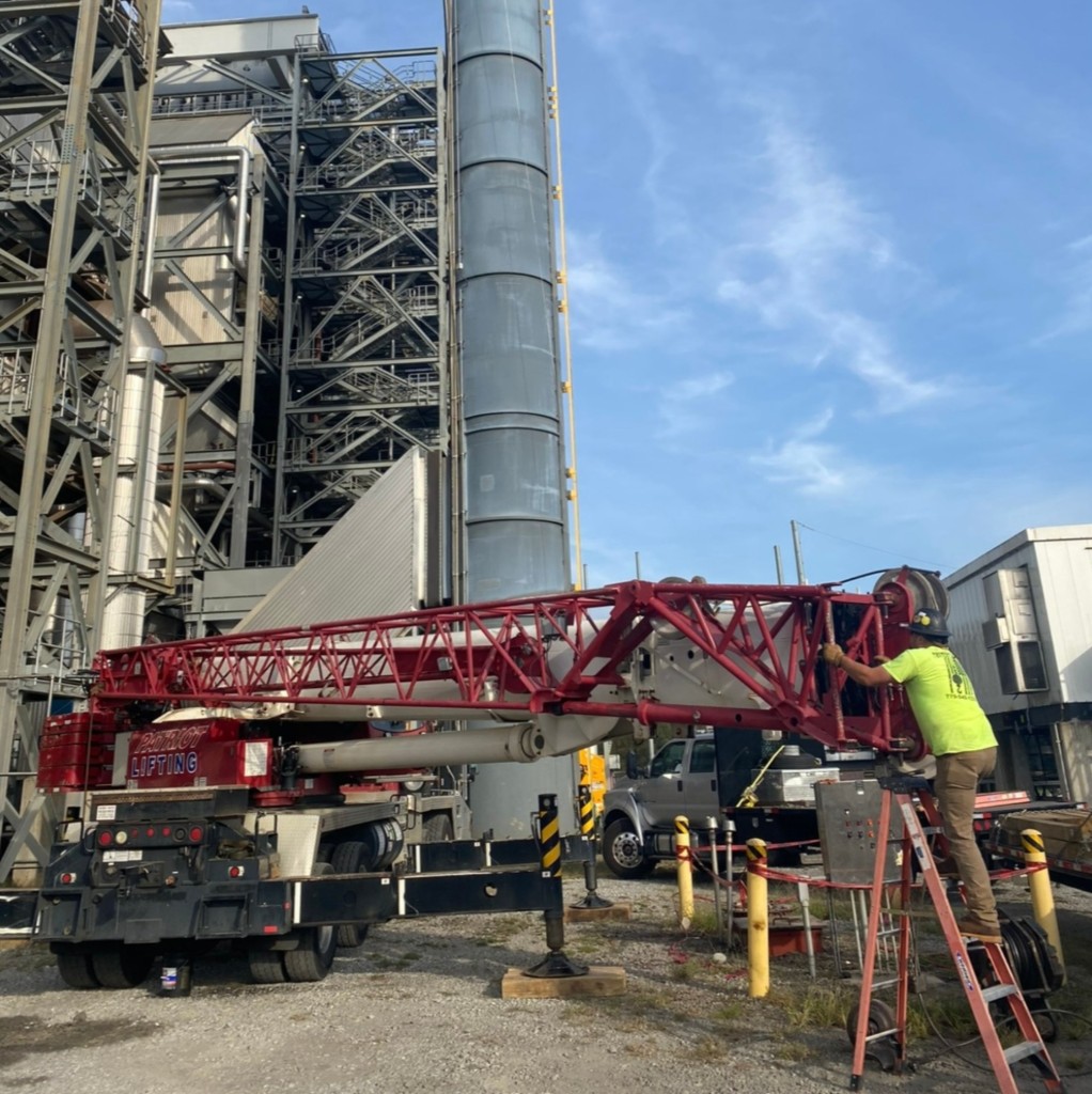 Patriot Lifting red crane working at an industrial petrochemical refinery facility