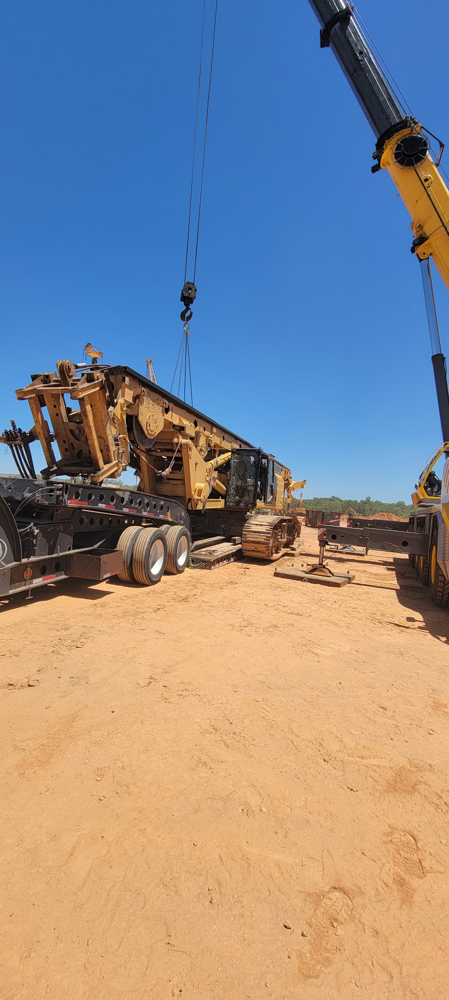 Yellow Caterpillar dozer staged for heavy haul transport