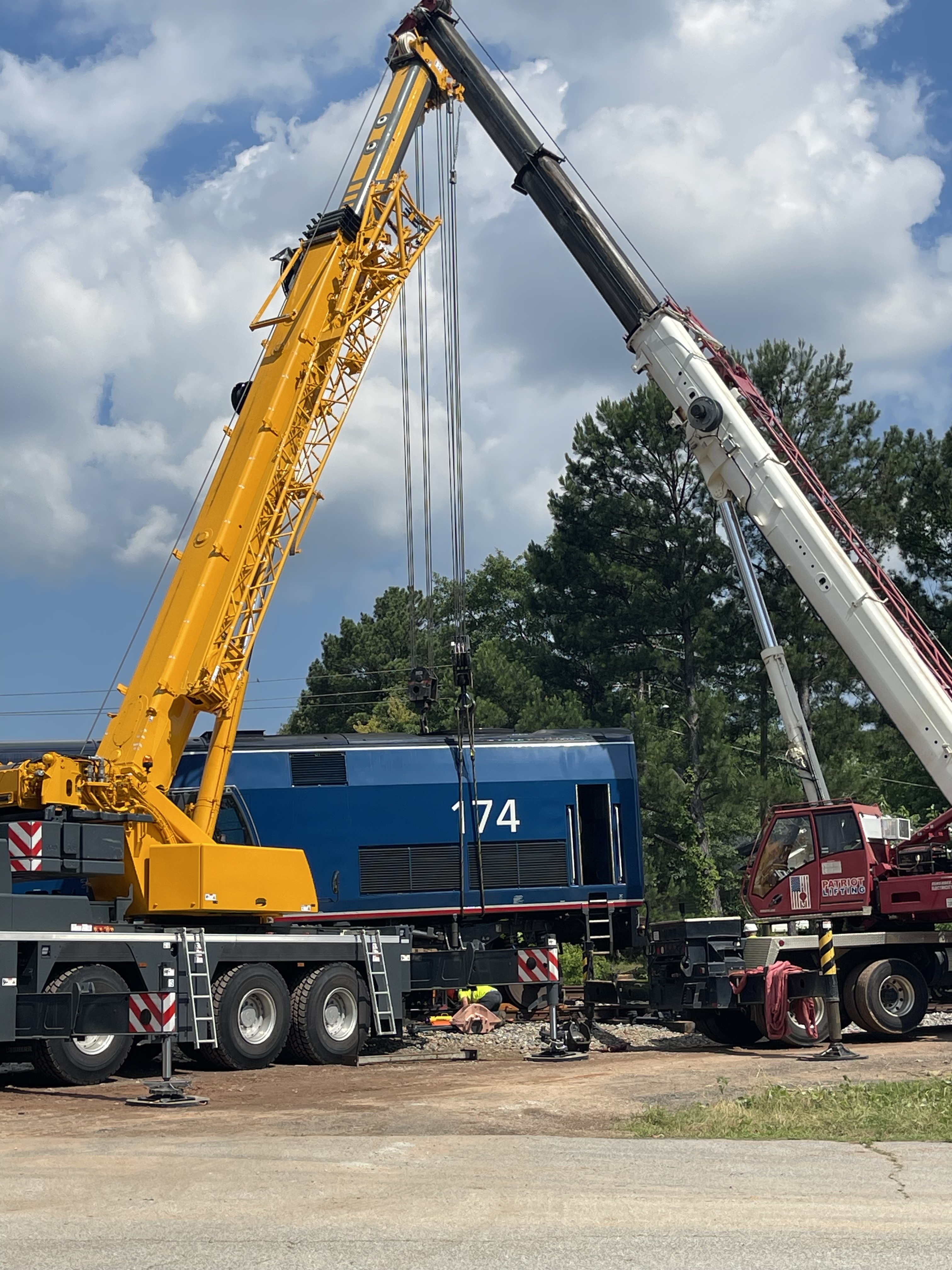 Two Patriot Lifting cranes performing a tandem lift of a 134-ton locomotive for repair