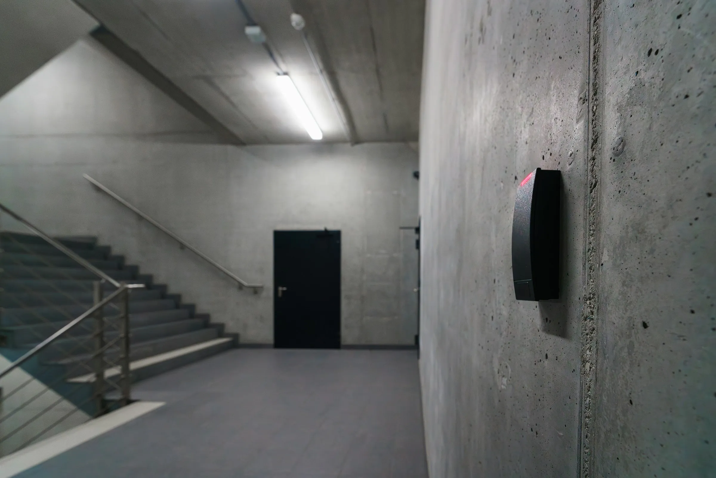 Access control card reader mounted beside secure door