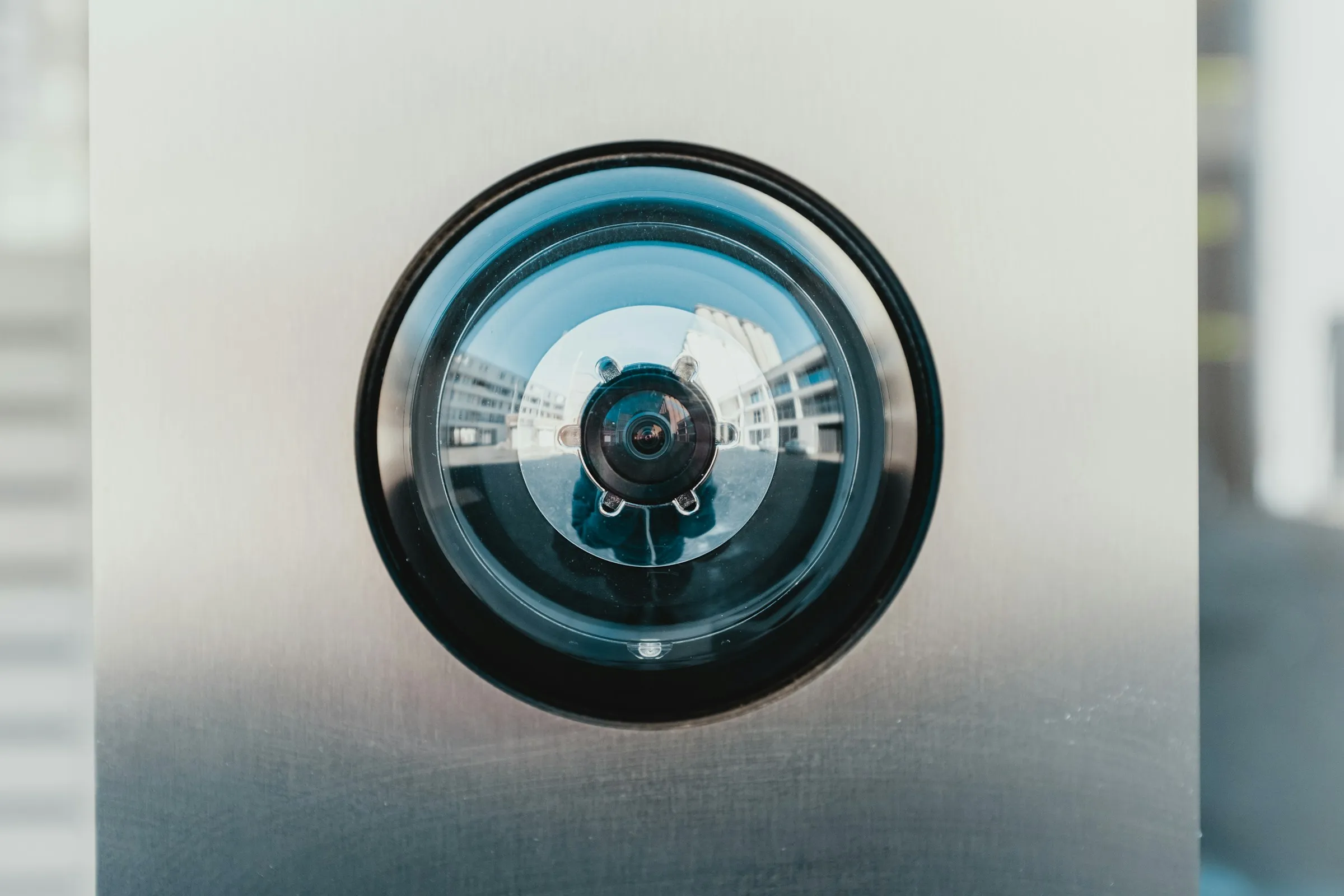 CCTV camera mounted on exterior wall covering entrance