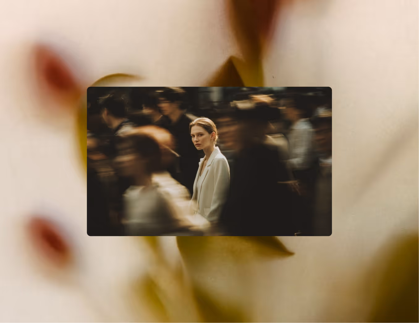 Woman in white jacket standing still amid blurred crowd movement in dim lighting.