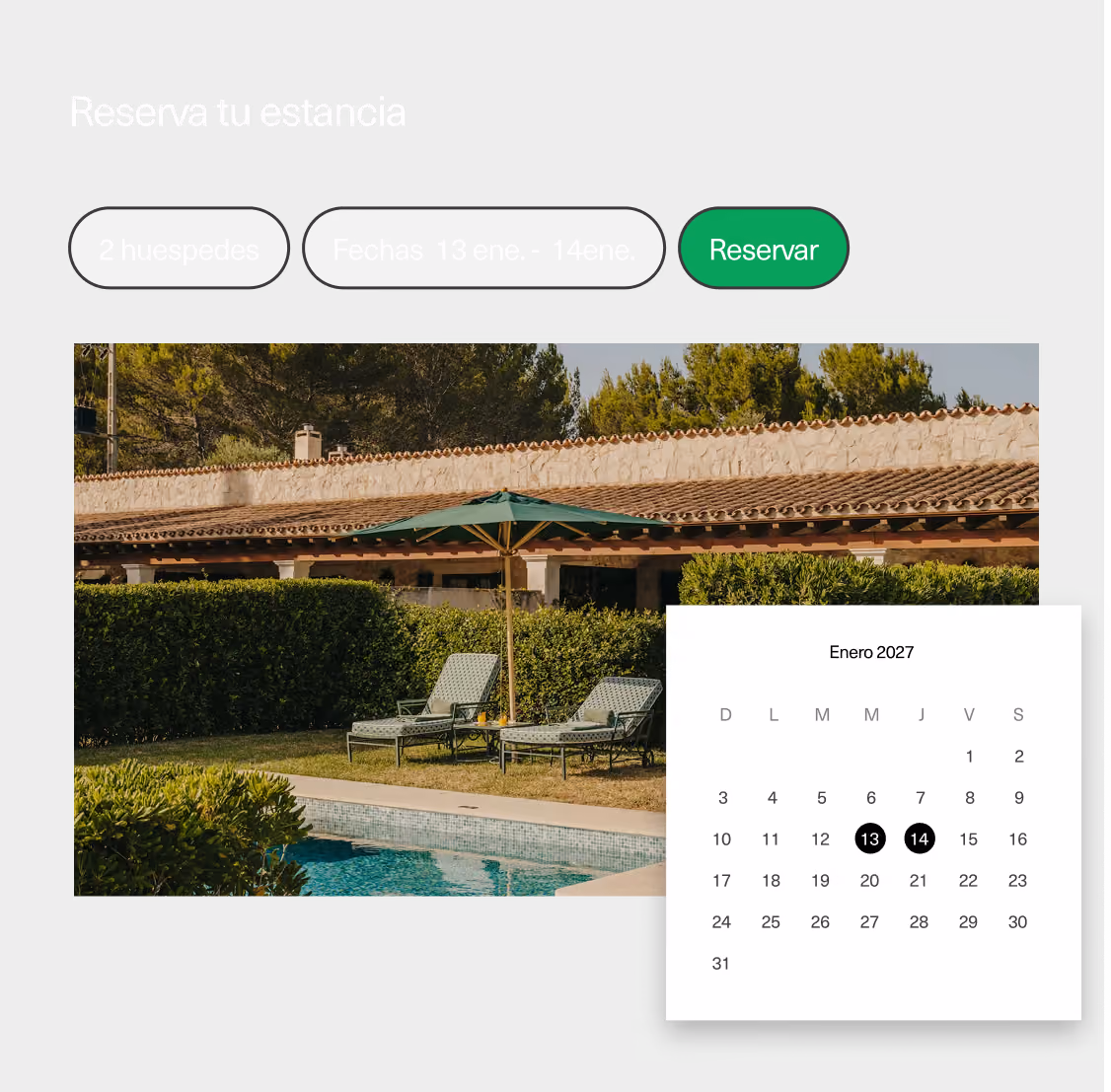 Outdoor pool with two loungers and a green umbrella in front of a house with tiled roof and hedges.