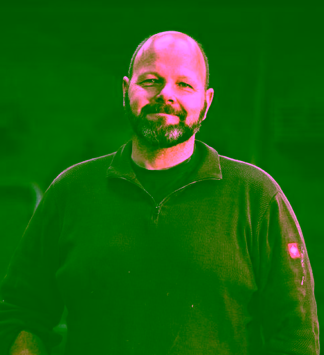 Portrait of a bearded contractor standing in a workshop