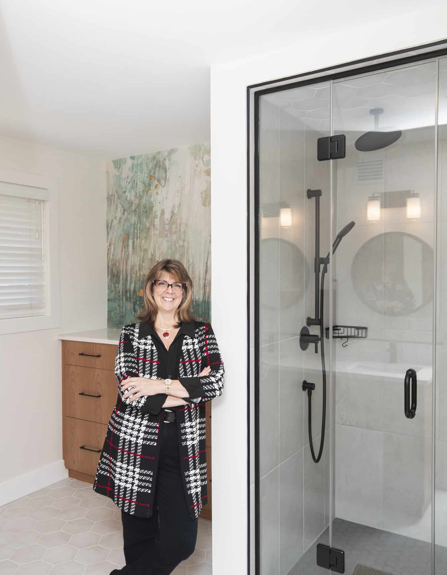 Photo of Lee Ellen Green standing in front of a stand up shower